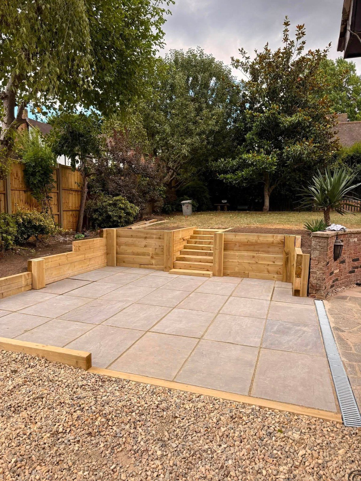 Garden dug out, retaining walls, patio and steps up to the lawn