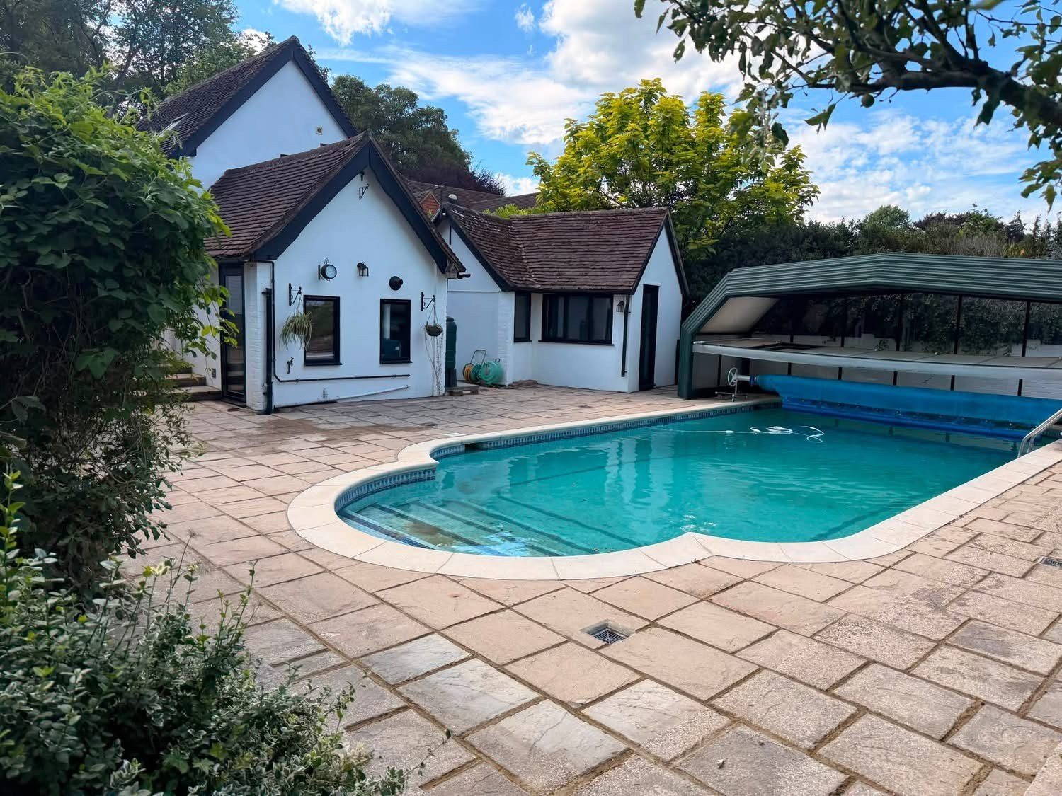 Paving relaid around a garden swimming pool