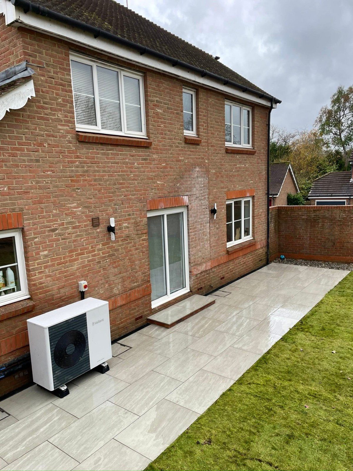 The finished porcelain patio wrapping round the house